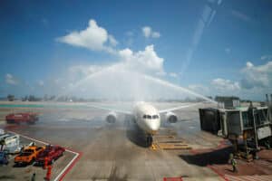 Ein Flugzeug am Flughafen von Phuket welches mit einer Wasserfontaene begruesst wird