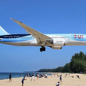 Flugzeug der TUI Gruppe beim Landeanflug auf Phuket, über dem Maikhao Strand.