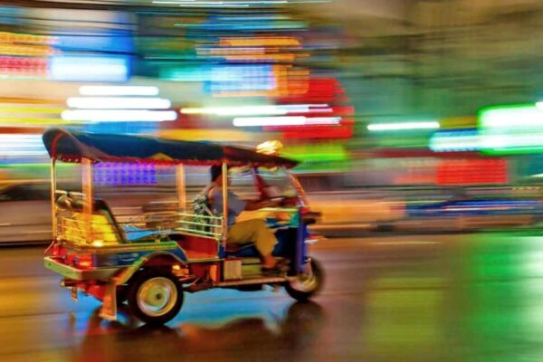 Ein Tuk Tuk welche durch abendlichen Stra0en von Bangkok fährt.