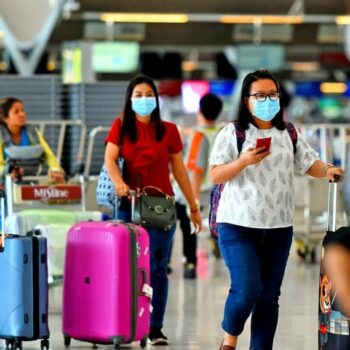 Touristen am Flughafen von Bangkok bei der Vorbereitung der Einreisedokumente.